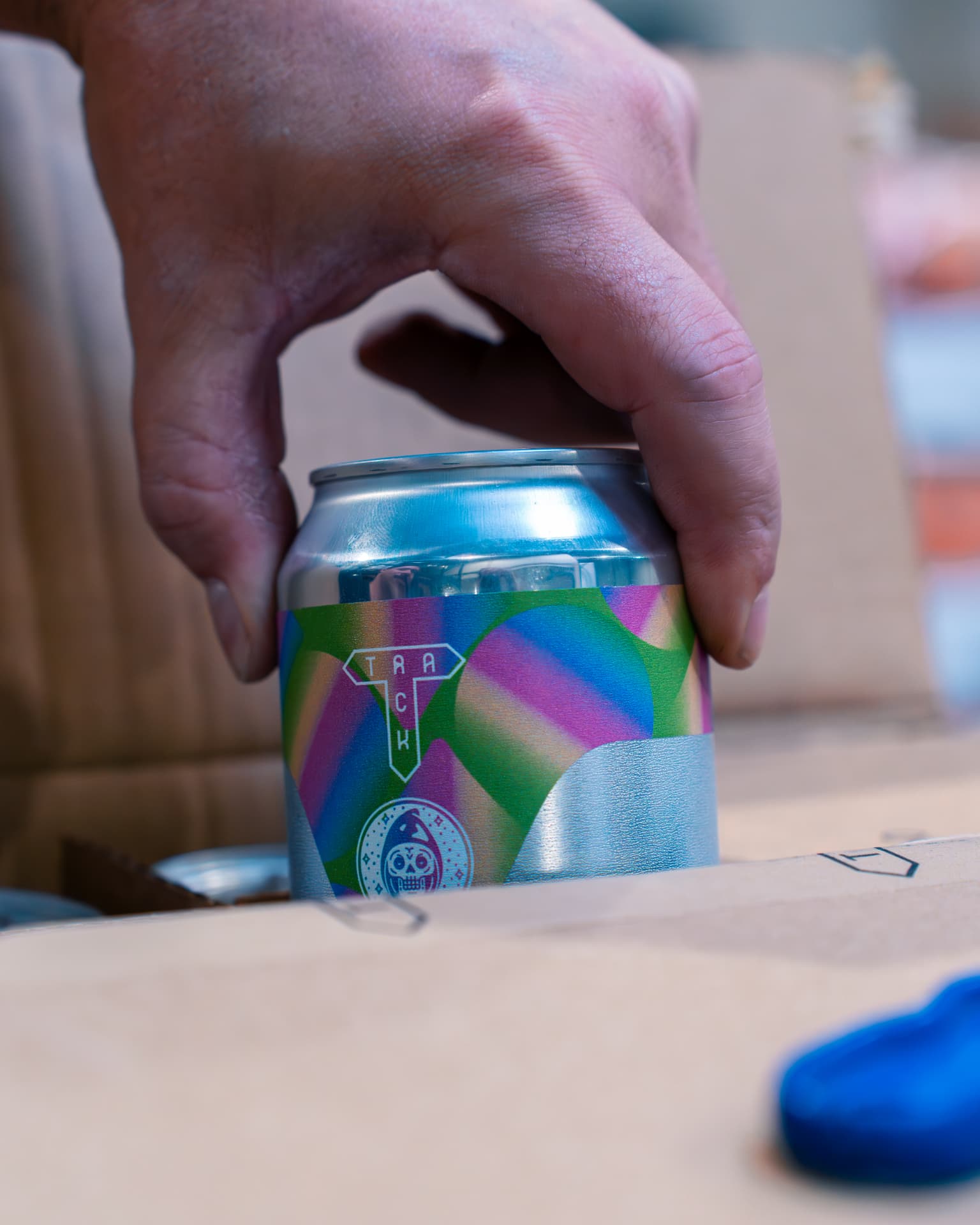 Canette Track saisie dans un carton lors de la préparation de commande